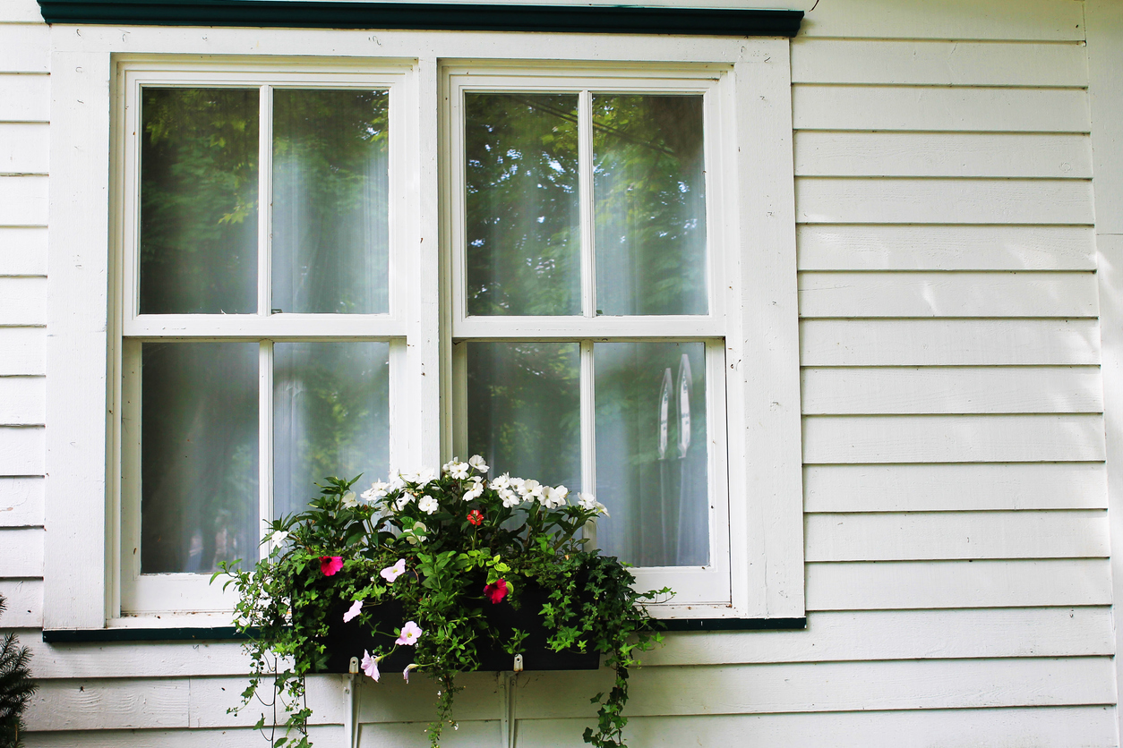 Close-up of an old fashioned window with a flower box.