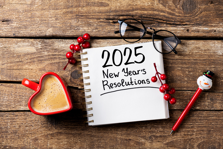 New year resolutions 2025 on desk. 2025 goals list with notebook, coffee cup on wooden table. Resolutions, plan, goals, action, checklist, idea concept. New Year 2025 resolutions, copy space