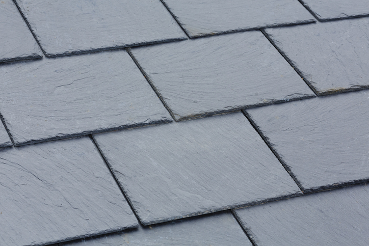 Closeup of traditional grey slate roof tiles on a pitched roof