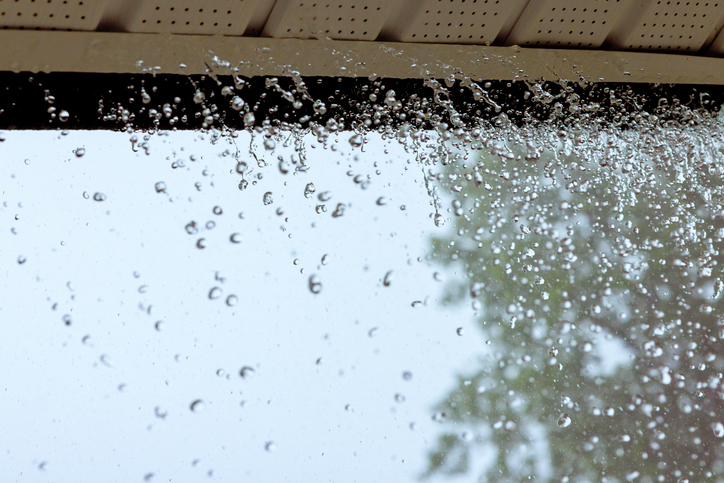 When it rains heavily, water pours out of over gutters.