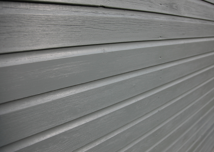 Tongue and groove wood wood on the side of a home.